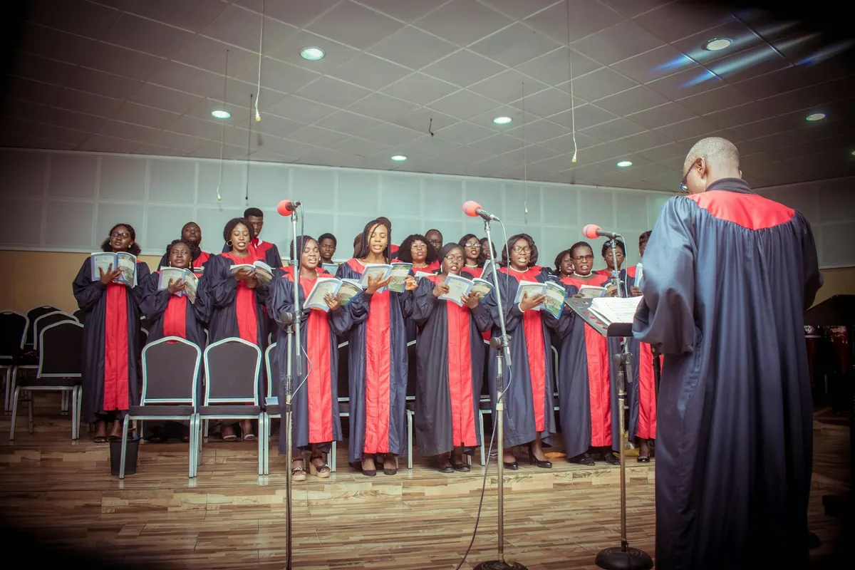 A youth choir in robes singing together